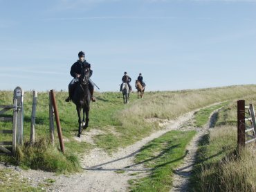 View of horse riders on Windover Hill, Sussex, England