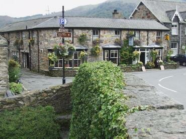 Scene showing the Tanronnen Inn from the bridge, Beddgelert, Snowdonia, Caernarvonshire (Gwynedd), Wales