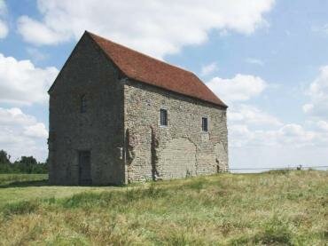 Scene showing 7th Century St. Peter's-on-the-Wall chapel, Bradwell-on-Sea, Essex