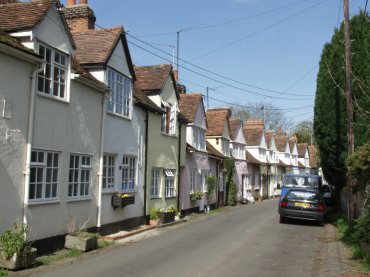 View of colour-washed houses in Church Lane, Castle Hedingham village, Essex