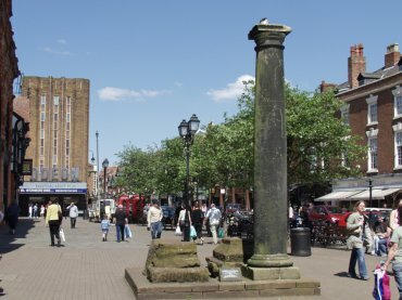 Scene showing a Roman column in the city centre, Chester, Cheshire, England