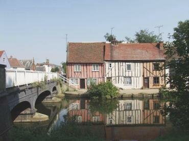 Scene showing 17th Century half-timbered cottages by the River Colne, Colchester, Essex, England