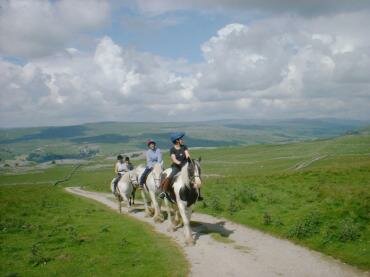 Horse riding above Wharfedale, Yorkshire Dales, North Yorkshire, England