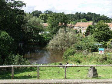 View of part of Lealholm village green and the River Esk, North Yorkshire, England
