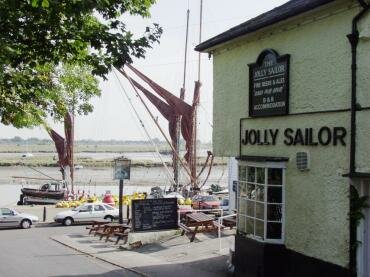 Photograph of the 16th Century Jolly Sailor on Hythe Quay with Thames Barges in the background, Maldon, Essex, England