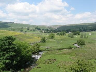 Malham Beck with Malham Cove in the distance, Yorkshire Dales, North Yorkshire, England