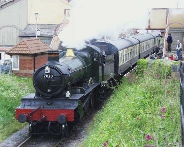 A steam locomotive, Manor Class 7820, 'Dinmore Manor', leaving Watchet Station, Somerset, England