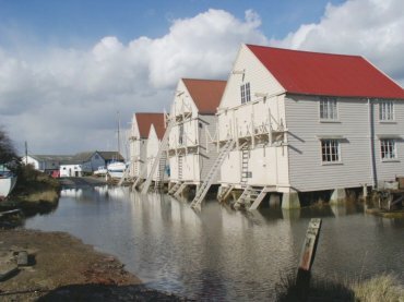 Picture of the Old Sail Lofts at high tide, Tollesbury, Essex, England