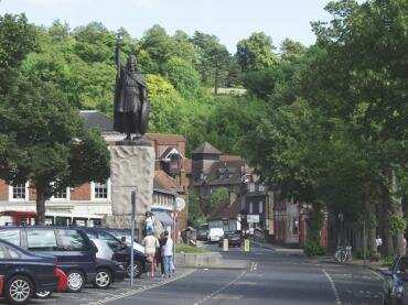 Scene showing King Alfred's statue in the lower part of the High Street, Winchester, Hampshire (Hants), England