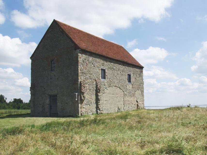 Scene showing the Saxon chapel of St. Peter on the Wall, Bradwell-on-Sea, Essex, England