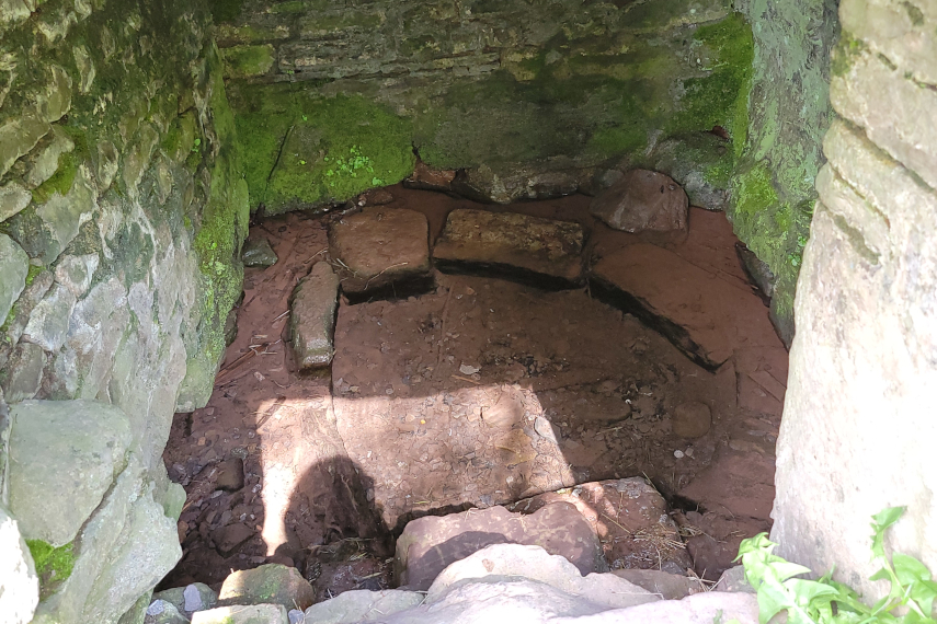 The clear spring seen through the front opening, Pen-y-Crug, Brecon, Brecknockshire, Wales.