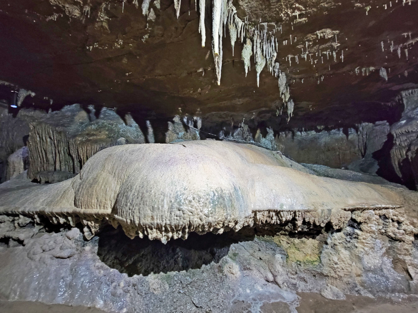A large rounded calcite flow in the main stream passage, Ingleborough Cave, Clapham, Yorkshire, England, Great Britain
