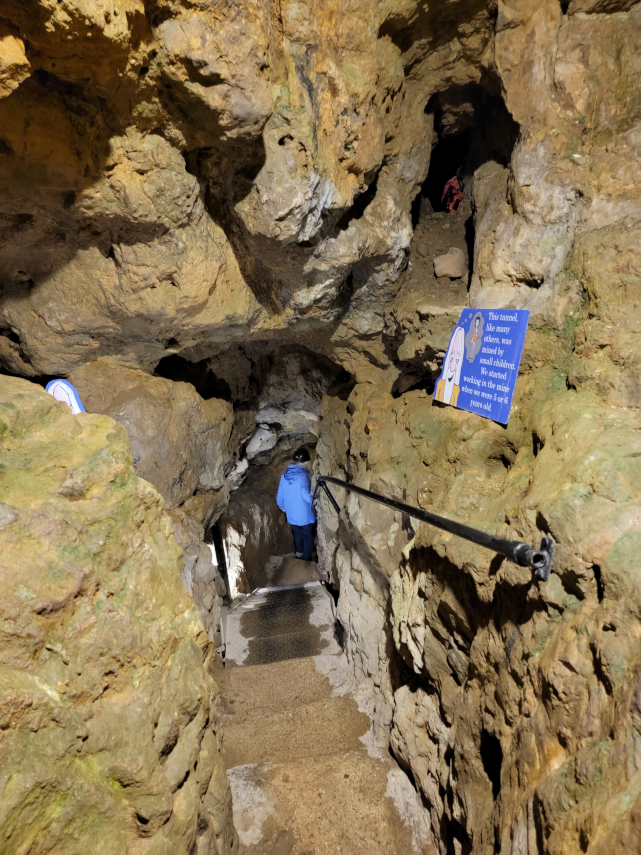 Moving through the Tunnel, Great Orme Mines, Llandudno, Caernarfonshire, Wales, Great Britain