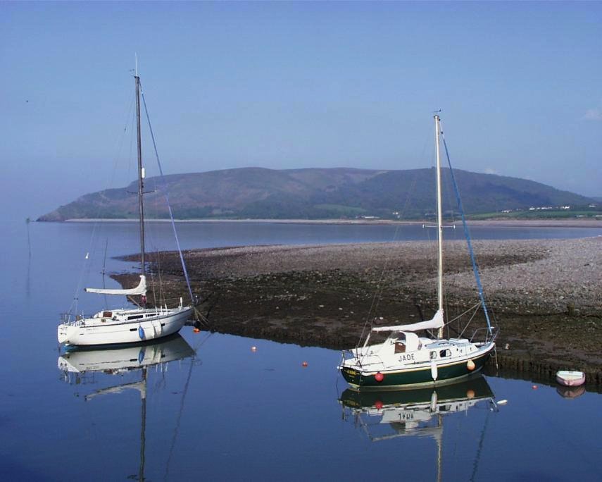 Scene from Porlock Harbour looking out over Porlock Bay on a tranquil evening, Porlock, Somerset, England