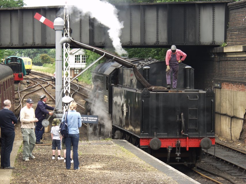 Steam locomotive taking on water at Sheringham Station on the North Norfolk Railway, Sheringham, Norfolk, England