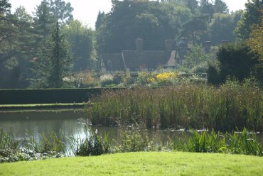 The house seen across the pond, Ightham Mote, Ightham, Kent, England