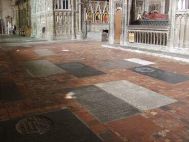 View of tombs and Medieval floor tiles, Winchester Cathedral, Winchester, Hampshire (Hants), England